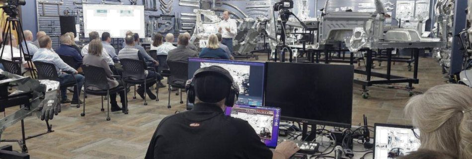 Live event production team streaming a corporate presentation inside a high-tech automotive display center